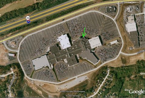 1986 Ford Bronco - An aerial view shows a mall complex with extensive parking lots filled with vehicles.