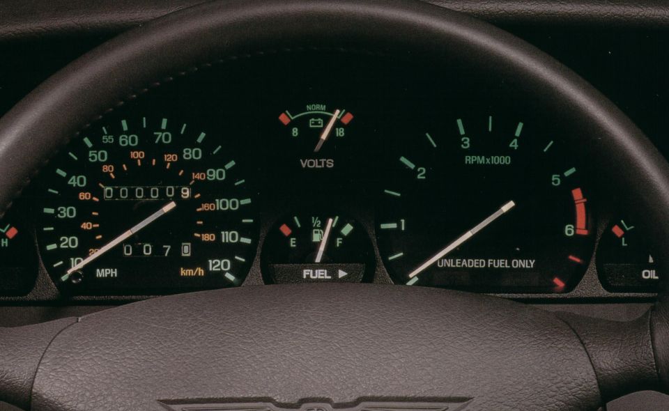 Car dashboard with speedometer, tachometer, fuel gauge, and volt meter. Odometer shows 000009