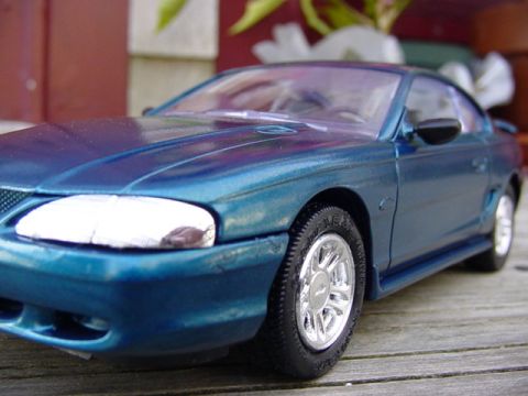 1995 Ford Mustang - This blue 1995 Ford Mustang model features a distinctive body style and a 3/4 front view.