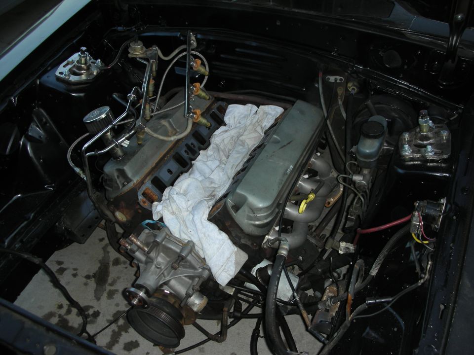 Inline engine bay with rag over valve cover and exposed manifolds