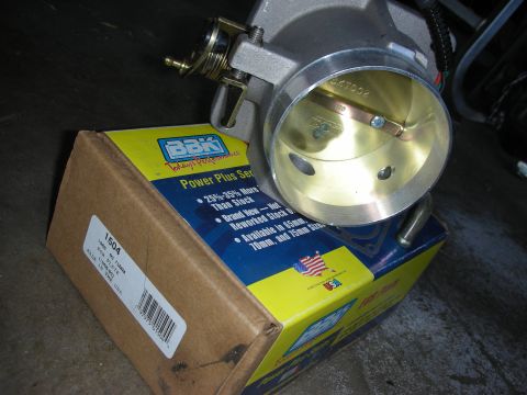 1998 Ford Crown Victoria - A BBK Power Plus Series throttle body is shown with its packaging, which includes part number 1504.