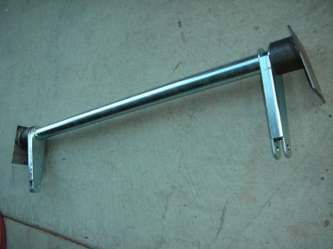 1998 Ford Crown Victoria - A metal bar with attached brackets is shown against a concrete background.