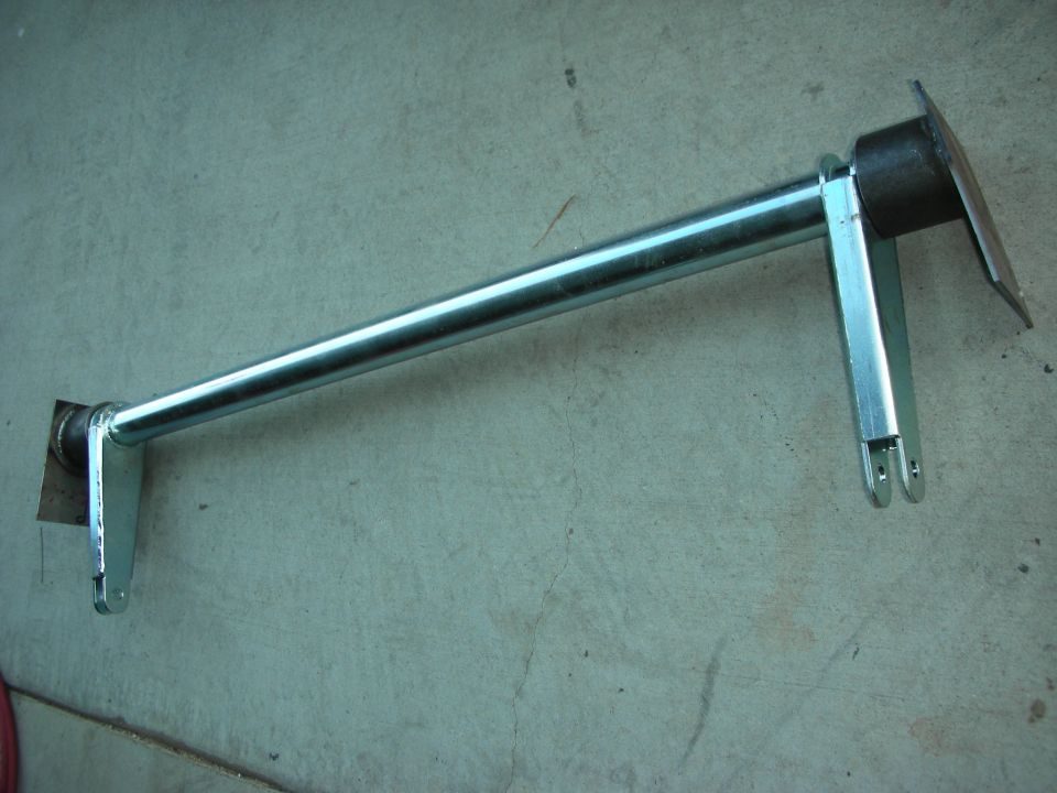Metal bar with two mounting brackets, one on each end, resting on a concrete surface