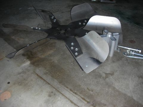 1998 Ford Crown Victoria - Radiator fan blade and mounting hardware are shown on a workshop floor.