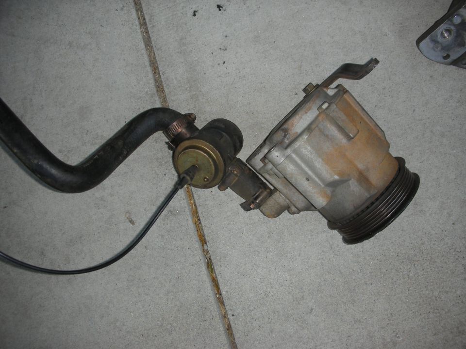 Vacuum hose connected to a valve assembly with a pulley system attached