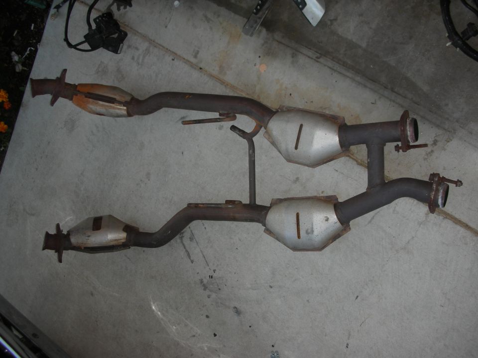 Exhaust system with two catalytic converters and pipes, laid out on concrete