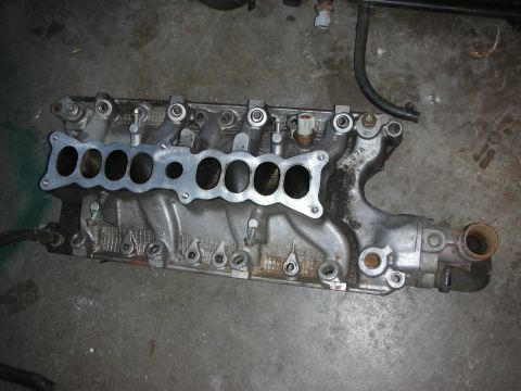 1998 Ford Crown Victoria - An intake manifold with eight ports is shown, likely for a V8 engine.