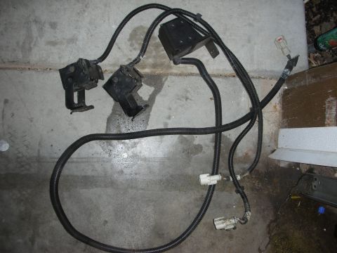 1998 Ford Crown Victoria - A disassembled automotive wiring harness lies on a concrete floor.