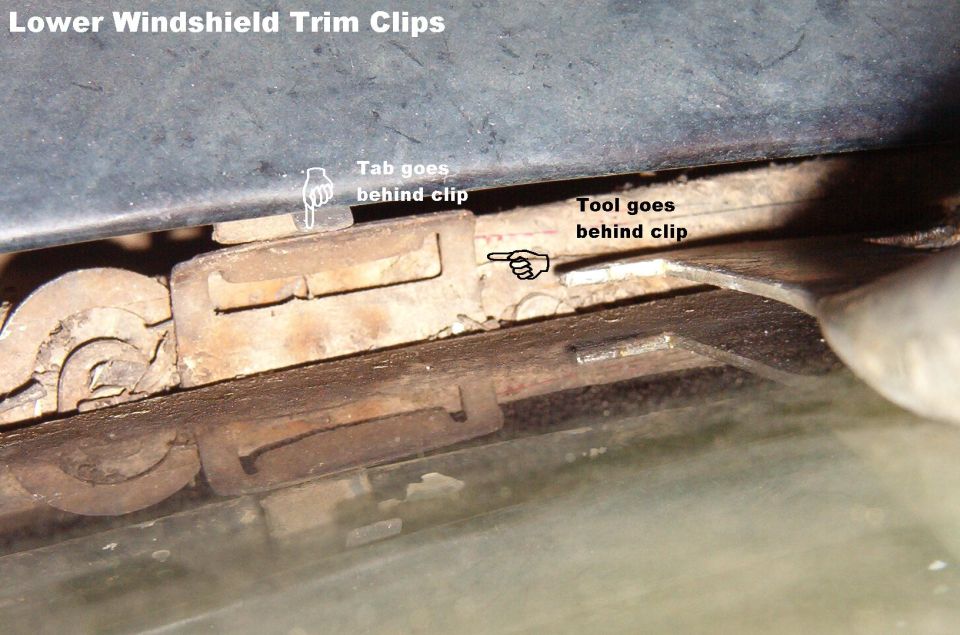 Underside view of lower windshield trim clips with labeled pointers
