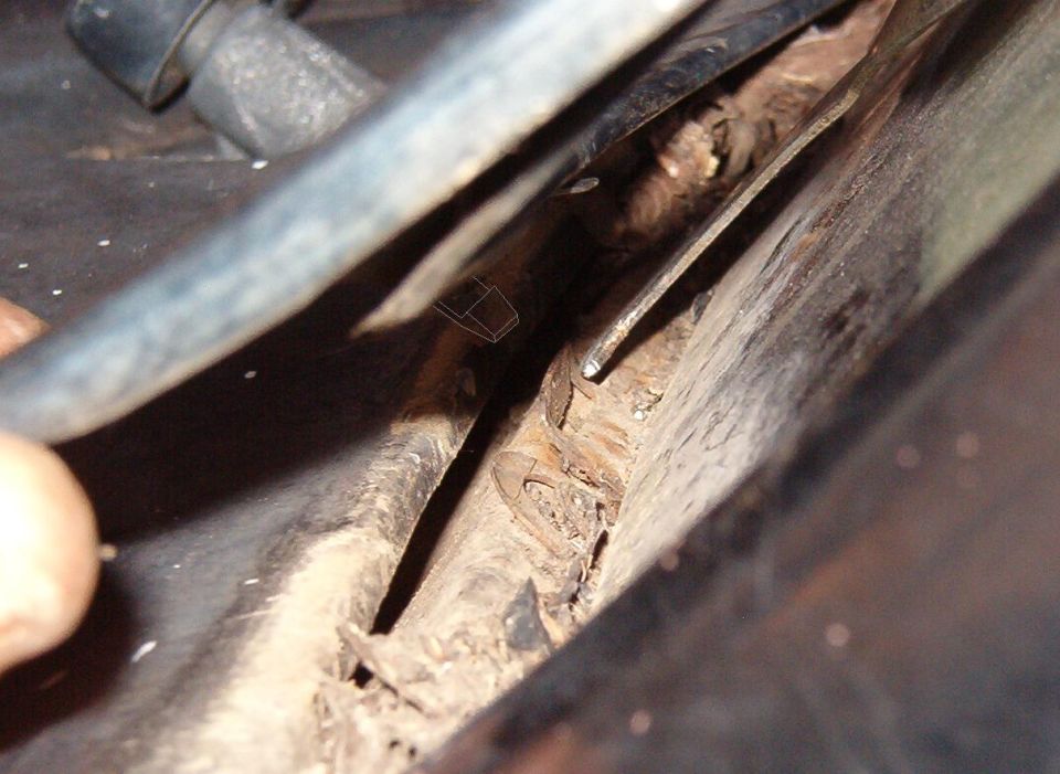 Close-up of a rusted windshield channel and seam