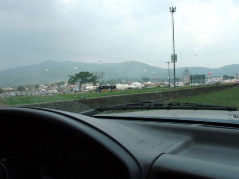1995 Ford F-150 - View from inside a vehicle shows a highway scene with mountains in the distance and a town along the roadside.