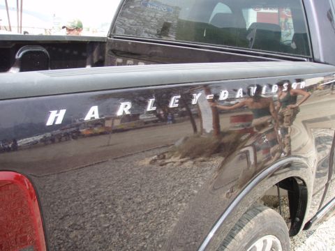1995 Ford F-150 - Harley-Davidson badging is visible on the side of this dark pickup truck.