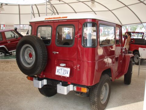 1995 Ford F-150 - This red Toyota Land Cruiser FJ40 is displayed with a spare tire mounted on the rear door and a Venezuelan license plate.