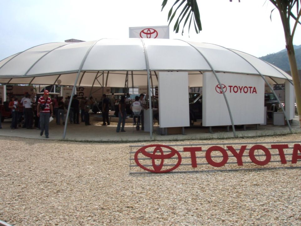 Toyota tent setup with people inside and a large TOYOTA sign out front