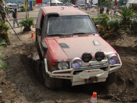 1995 Ford F-150 - This red SUV is equipped for off-road challenges, a snorkel and auxiliary lights.