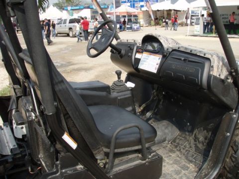 1995 Ford F-150 - The interior of a side-by-side UTV features camouflage accents on the dashboard and a digital display.