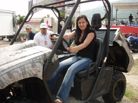 1995 Ford F-150 - Woman sits in a RHINO 660 utility vehicle with camouflage accents.