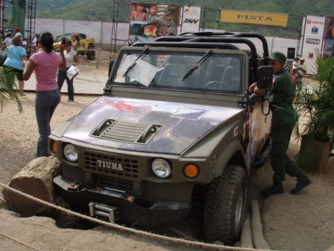 1995 Ford F-150 - A Tiuna military vehicle is shown parked on a dirt surface with a log in front.