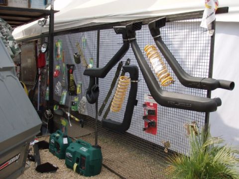 1995 Ford F-150 - Various off-road vehicle accessories, including snorkels, are displayed for sale at an outdoor event.