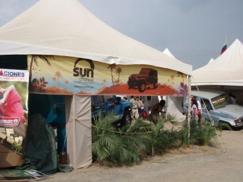 1995 Ford F-150 - An outdoor event features tents and several vehicles, with a light blue SUV prominently visible.