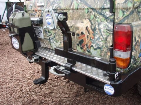 1995 Ford F-150 - Aftermarket rear bumper with accessories, including a jerry can mount and spare tire carrier.