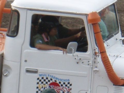 1995 Ford F-150 - The driver of a white truck is visible inside the cab, with an orange snorkel on the exterior.