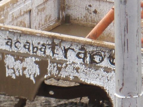 1995 Ford F-150 - A close-up of a weathered truck bed shows handwritten text and cracked paint.