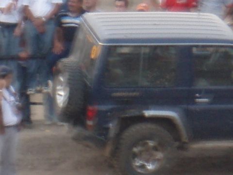 1995 Ford F-150 - A dark blue SUV is seen from the side with a spare tire mounted on the rear door.