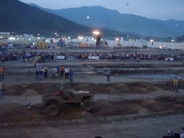 Jeep driving on an off-road course with spectators in the background