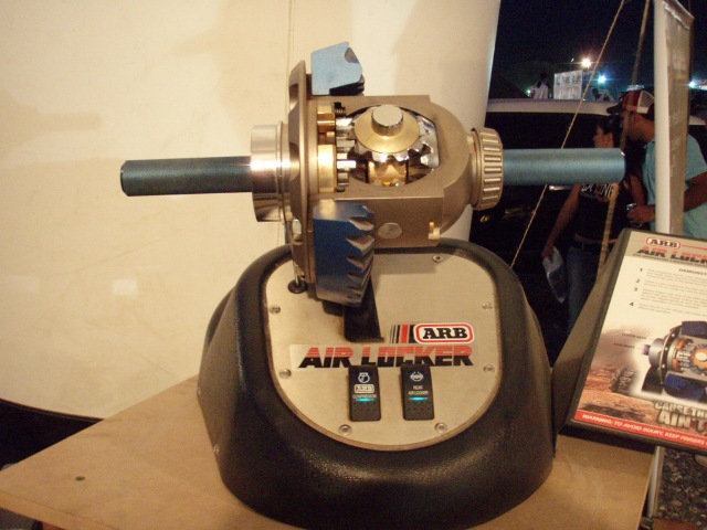 ARB Air Locker differential with internal gears visible, mounted on a display base with switches