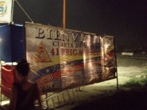 1995 Ford F-150 - A large banner with Spanish text and national colors is displayed outdoors at night.