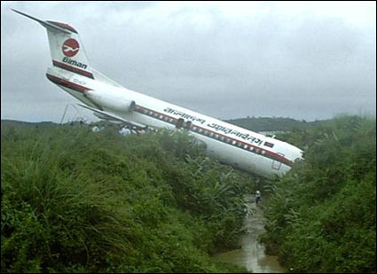 1990 Ford Bronco - A white Biman Bangladesh Airlines jetliner with red trim sits nose-down in dense green vegetation after overrunning a runway, its T-tail ra…