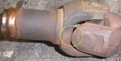 1992 Ford Explorer - A close-up view of a worn driveshaft universal joint, possibly indicating a need for replacement.