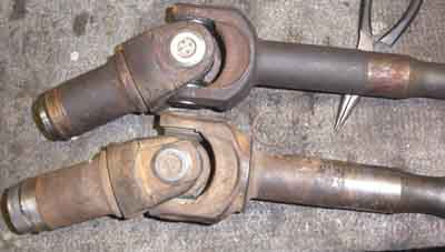 1992 Ford Explorer - Two driveshafts are shown, one above the other, with visible universal joints and metal shafts.