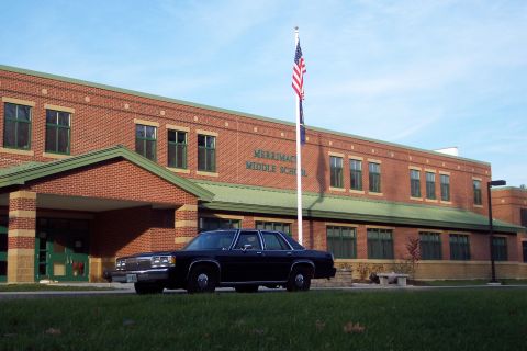 2001 Ford Crown Victoria - A black sedan is parked on the grass in front of Merrimac Middle School.