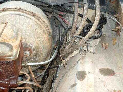 1978 Ford Bronco - Close-up view of the brake booster and master cylinder assembly in an engine bay, showing various hoses and wiring.
