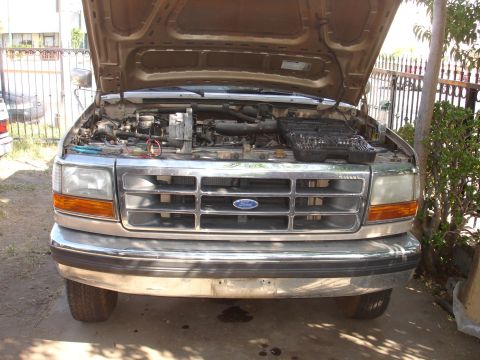 1992 Ford F-350 - Front view of a 1992 Ford F-350 truck with the hood open, revealing the engine compartment and a toolbox.