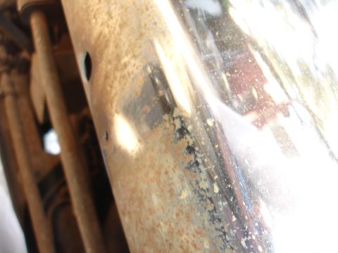 1992 Ford F-350 - Close-up of a rusty chrome bumper, showing wear and tear.
