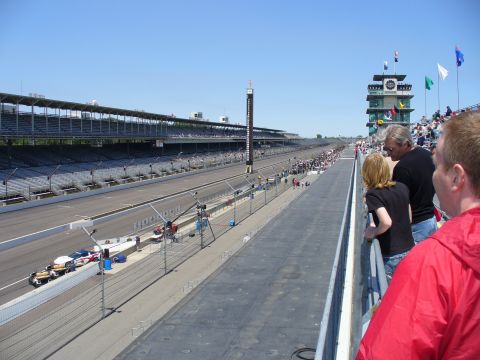 1991 Ford Probe - View of the Indianapolis Motor Speedway race track on a clear day, showing grandstands and the control tower.