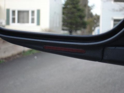1999 Ford Crown Victoria - Close-up of the interior trim of a 1999 Ford Crown Victoria's side mirror assembly.