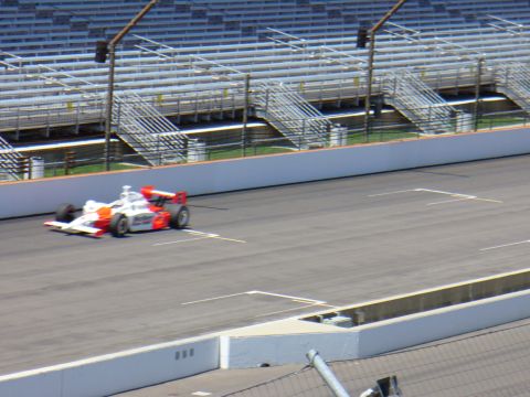 1991 Ford Probe - An IndyCar races on a track with empty grandstands visible.