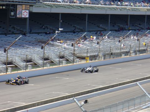 1991 Ford Probe - Race cars compete on a track with spectators in the grandstands.