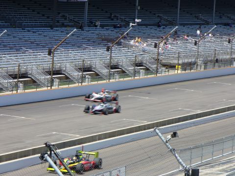 1991 Ford Probe - Multiple race cars compete on a track with empty grandstands visible in the background.