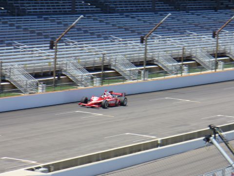 1991 Ford Probe - A red IndyCar races on a track with empty grandstands visible.