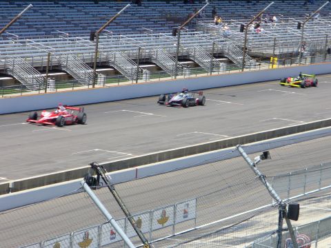1991 Ford Probe - Race cars compete on a track with empty grandstands visible.