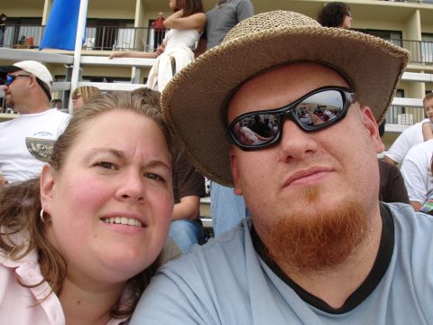 1996 Ford Bronco - Two people pose for a selfie at an outdoor event, with spectators visible in the background.