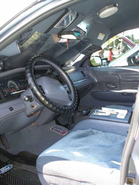 1998 Ford Crown Victoria - Interior view of a 1998 Ford Crown Victoria, highlighting the dashboard and seating.