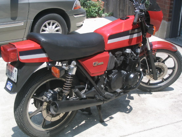 Red Kawasaki GPz 550 motorcycle, left rear view, parked on pavement