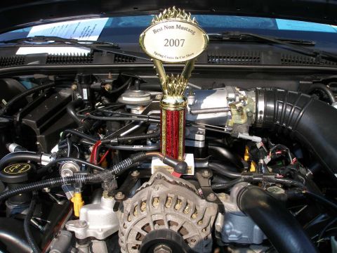1998 Ford Crown Victoria - A trophy sits in the engine bay of a car, awarded at a 2007 car show.