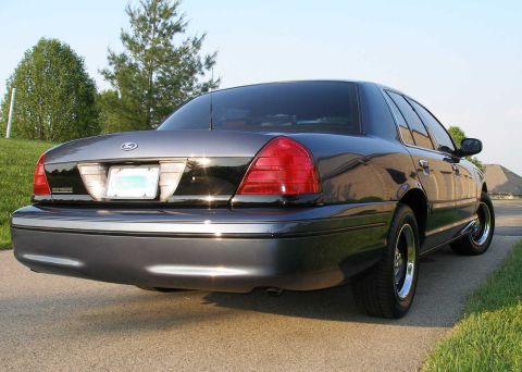 1998 Ford Crown Victoria - Rear view of a dark 1998 Ford Crown Victoria parked on a paved surface.